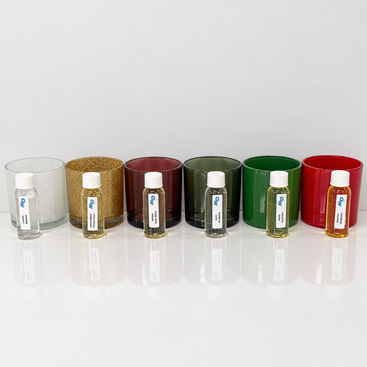 Christmas ’95 fragrance oils arranged with six colorful Monticiano candle jars