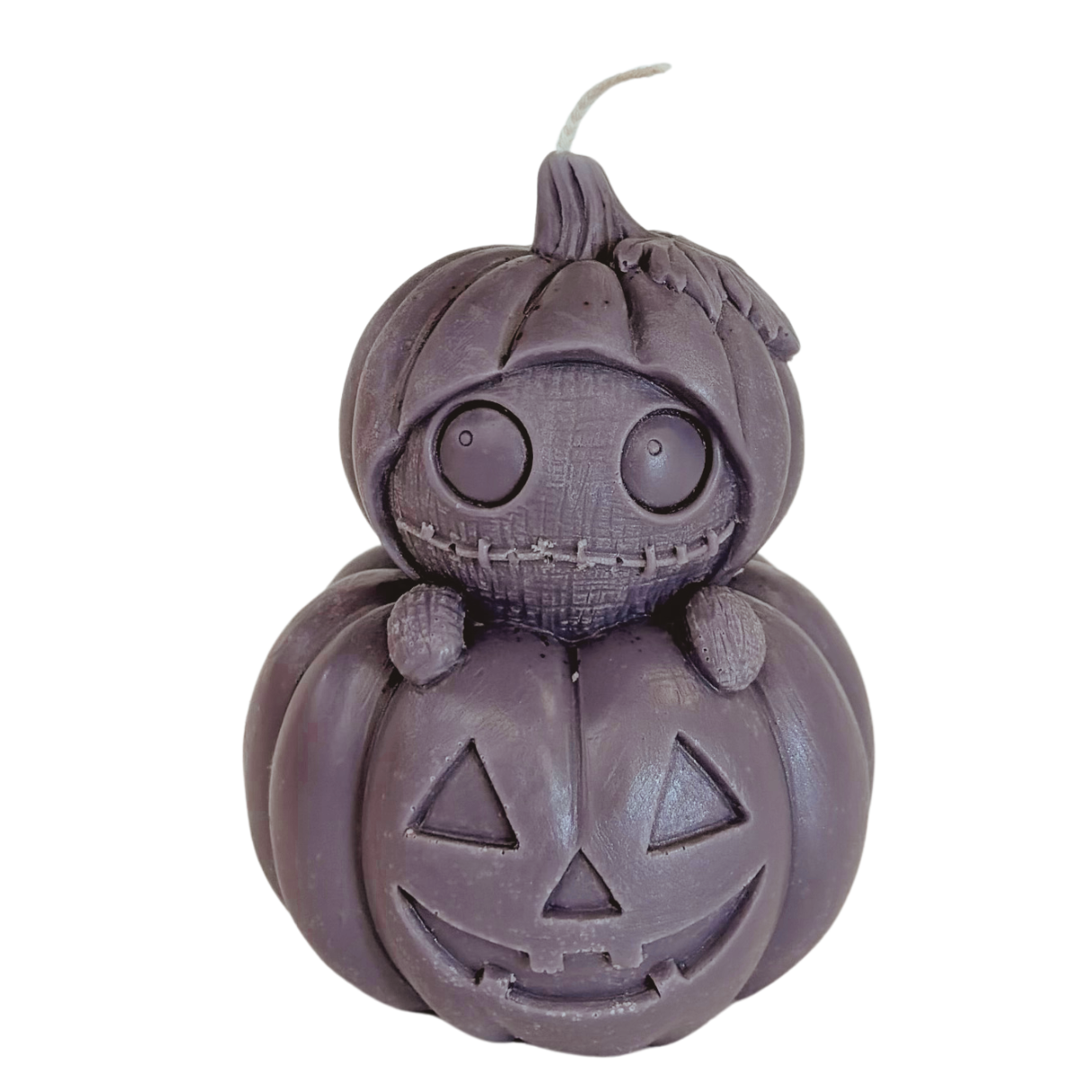 A dark purple double-gourd Halloween candle shaped like stacked pumpkins, with a stitched face on top and a carved jack-o'-lantern below